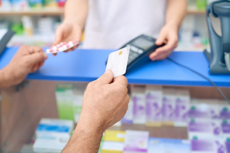 customer-paying-pills-using-credit-card - 900x600.jpg